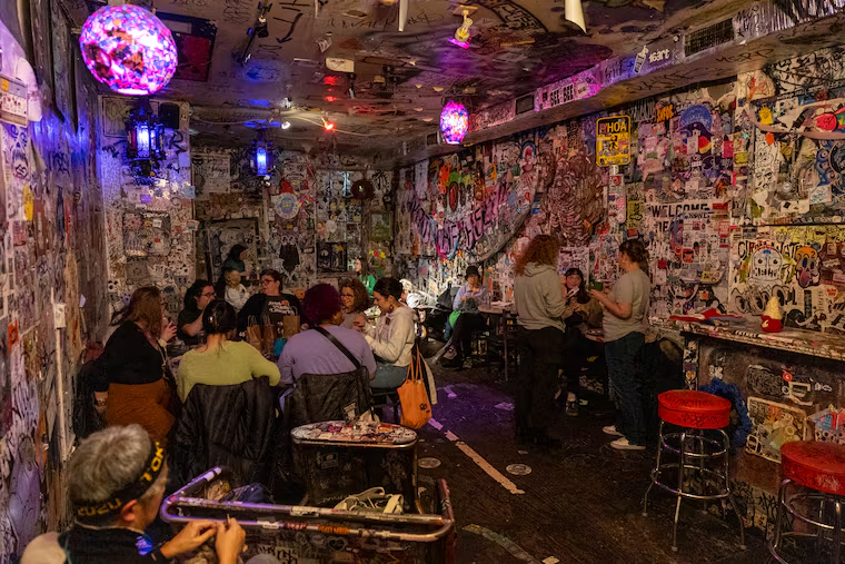 Inside Tattooed Mom — walls covered in stickers and art